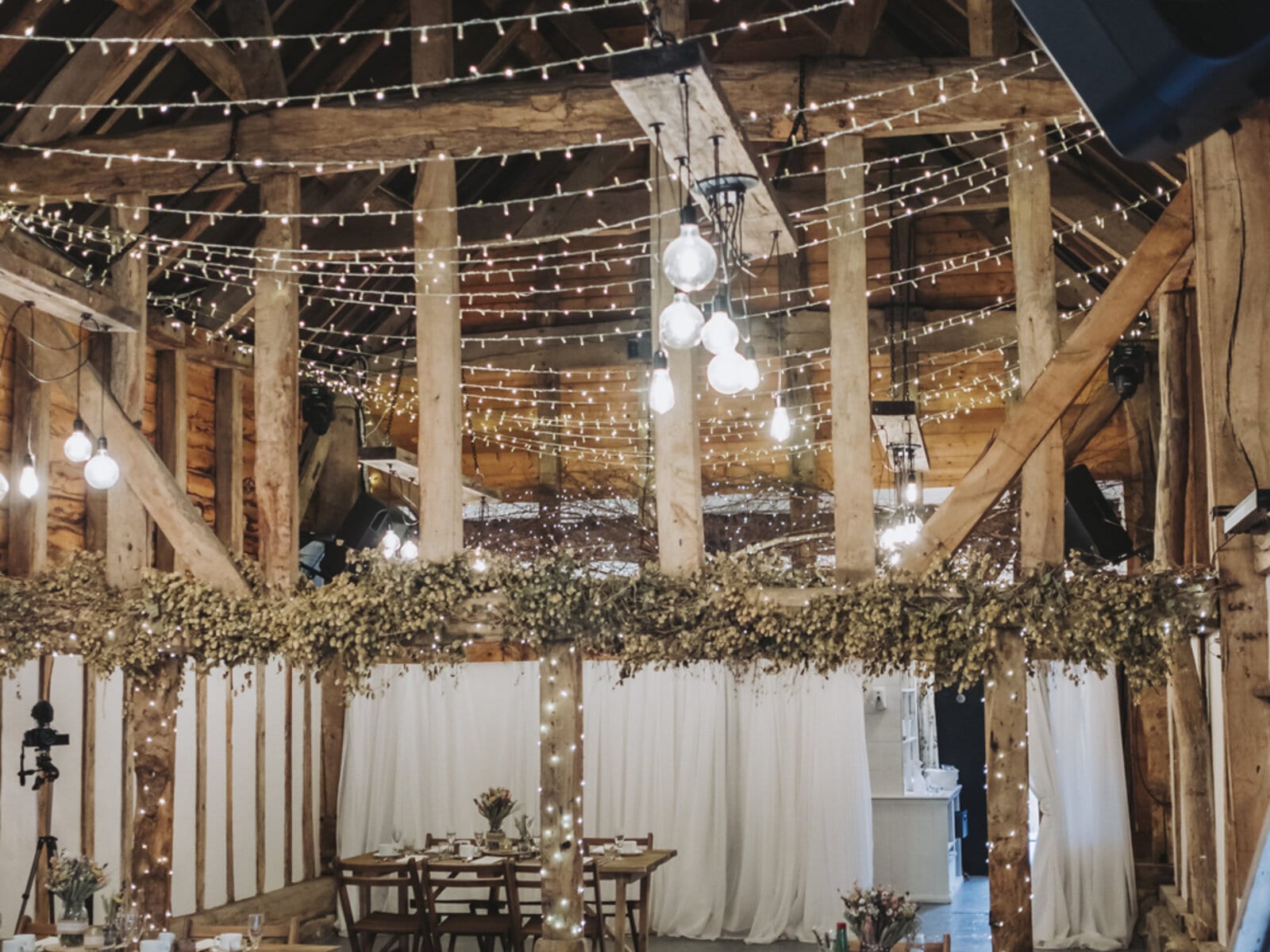 The Apple Barn at The BarnYard under a canopy of fairy lights, dressed for a seated celebration
