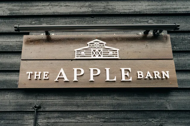 The Apple Barn sign on the black timber barn