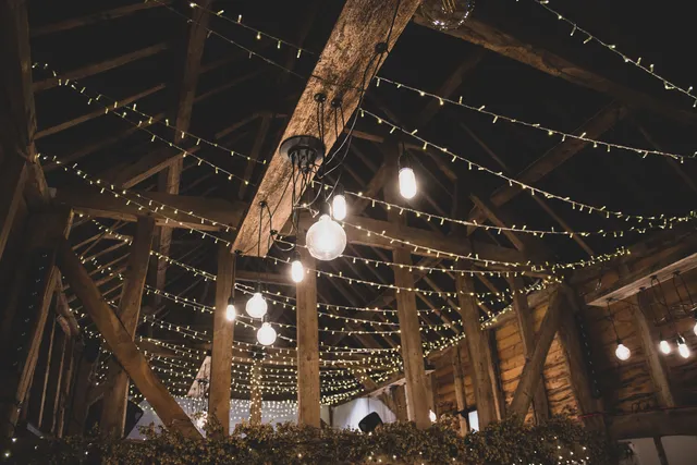 Fairy lights and festoons strung across the Apple Barn's beams