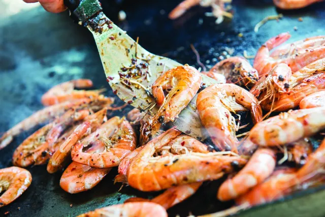 Prawns sizzling on the grill at a BarnYard reception