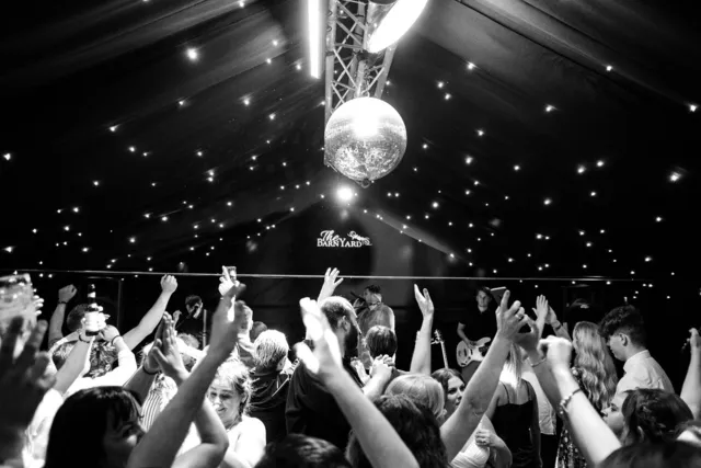 A packed dance floor under the mirror ball