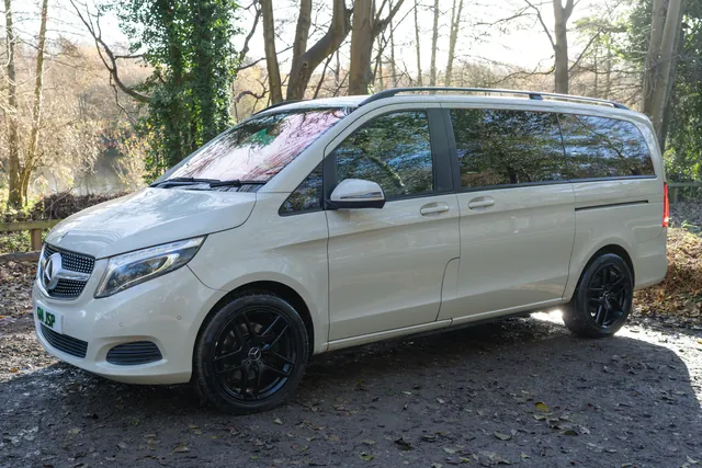 The cream Mercedes V-Class people carrier on a woodland lane