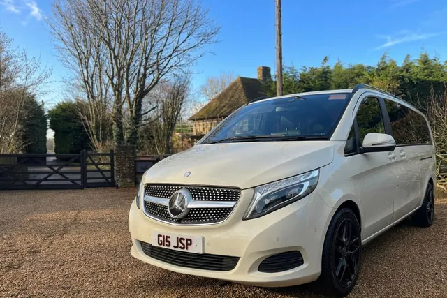 The cream Mercedes V-Class waiting by a five-bar gate on a bright winter morning