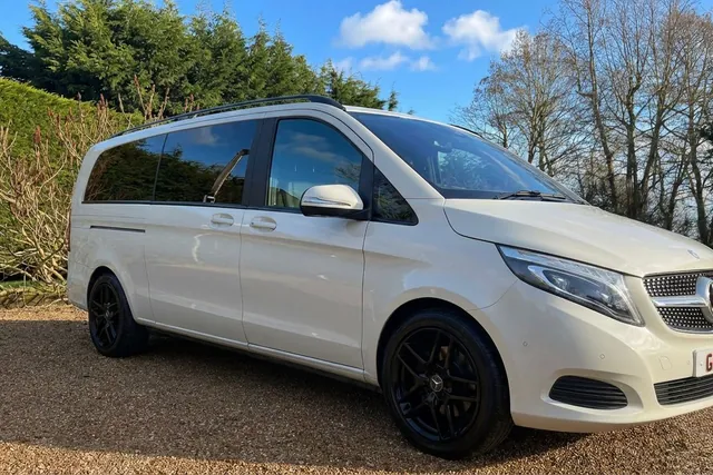 Side profile of the cream Mercedes V-Class on a gravel drive