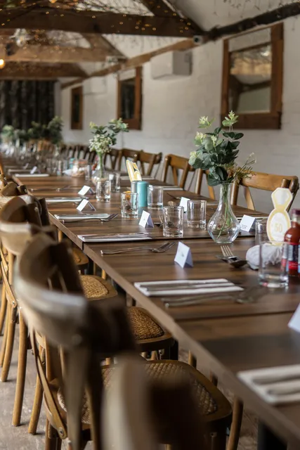 The long table at The Roost dressed with glassware and foliage