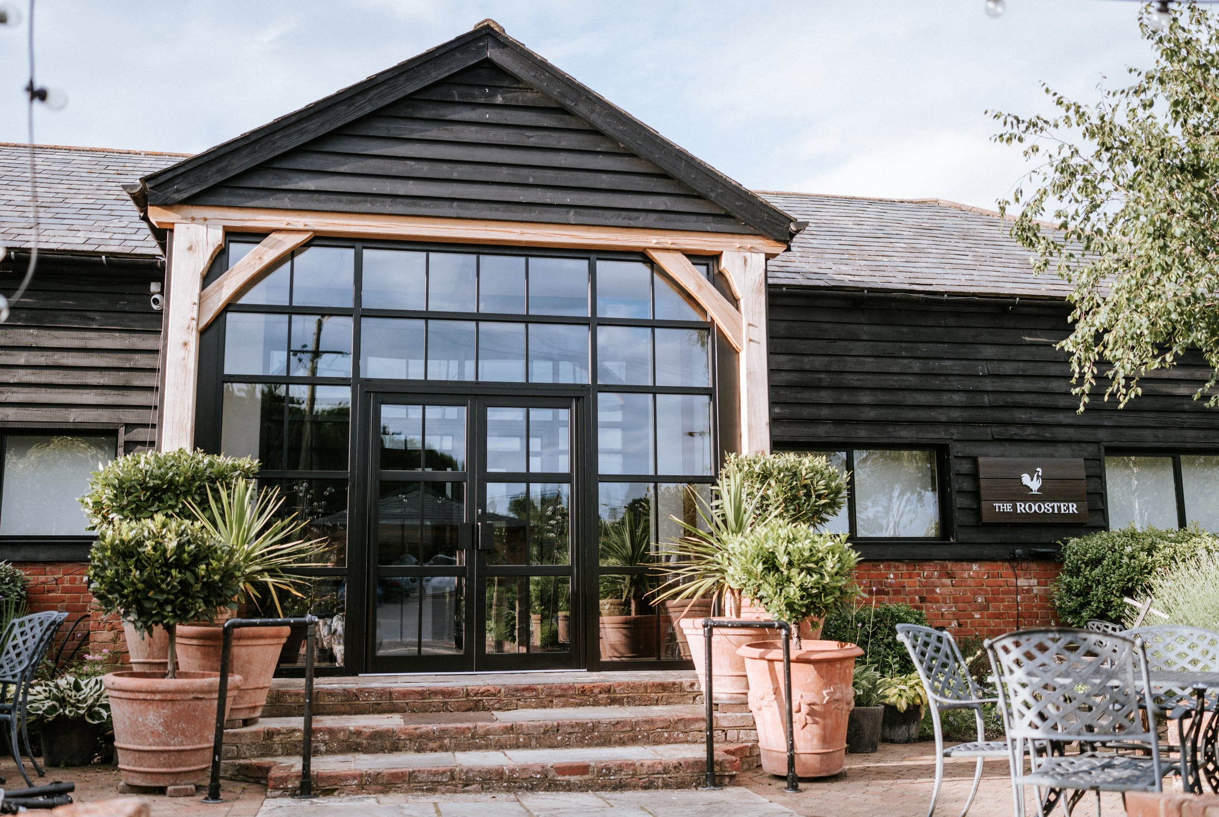 The entrance to The Rooster at The BarnYard on a bright day