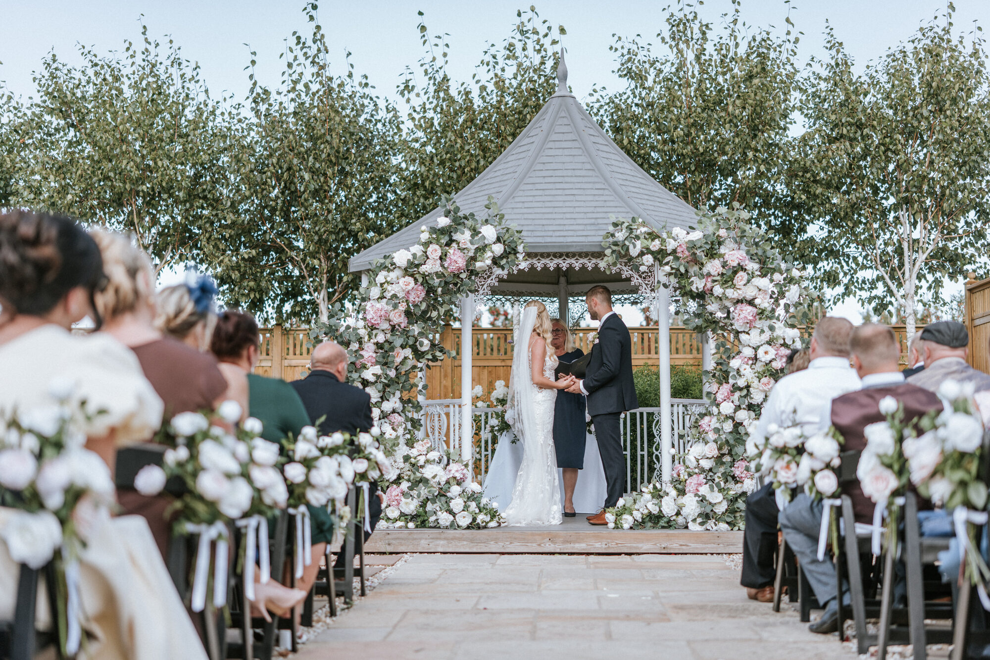 Chairs set out facing the ceremony gazebo at The BarnYard, with lavender in the foreground