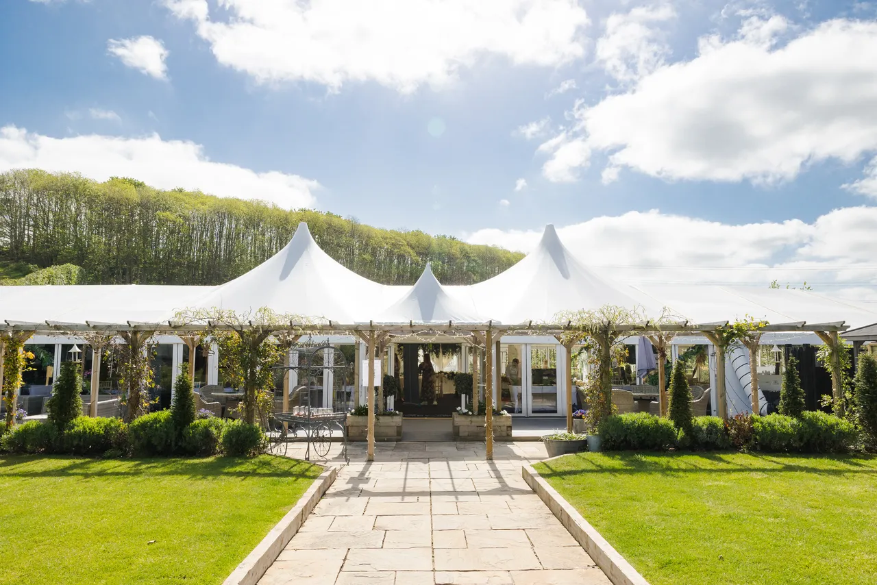 A gazebo wedding ceremony in the gardens at The BarnYard