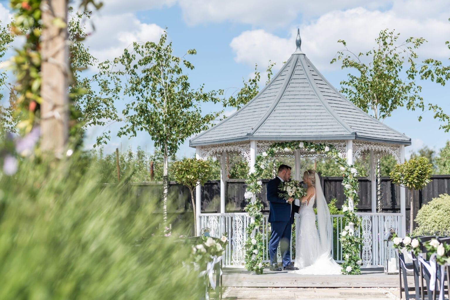 A wedding ceremony at the floral gazebo