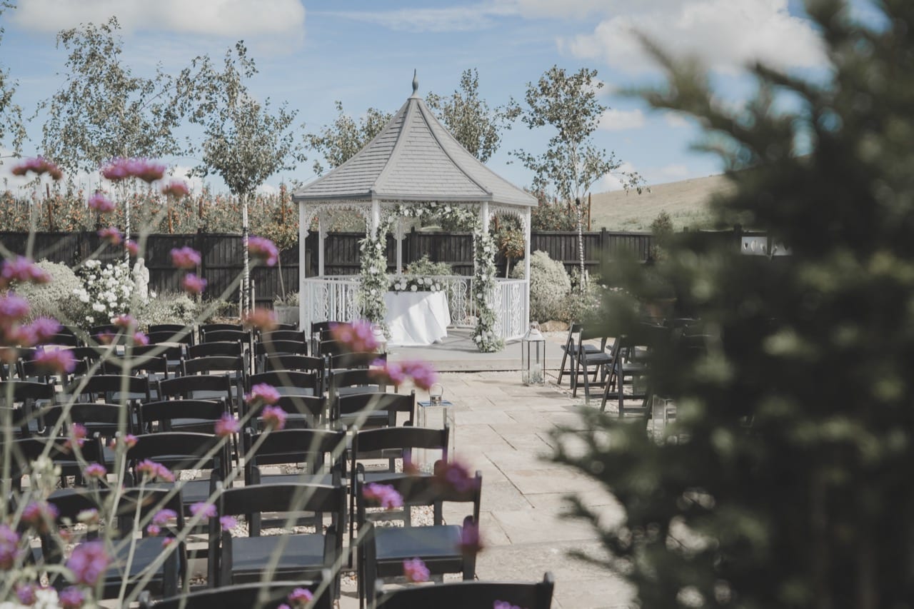 The Lavender Walk ceremony gazebo at The BarnYard, lined with lavender